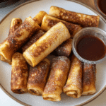 cinnamon roll french toast rolls on a white plate with the words cinnamon roll french toast rolls