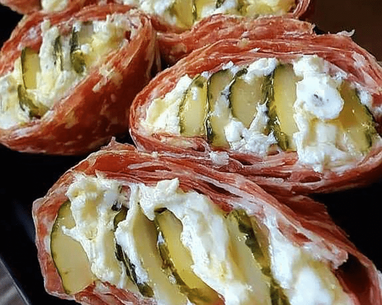 several slices of meat sitting on top of each other in a black bowl with white cheese